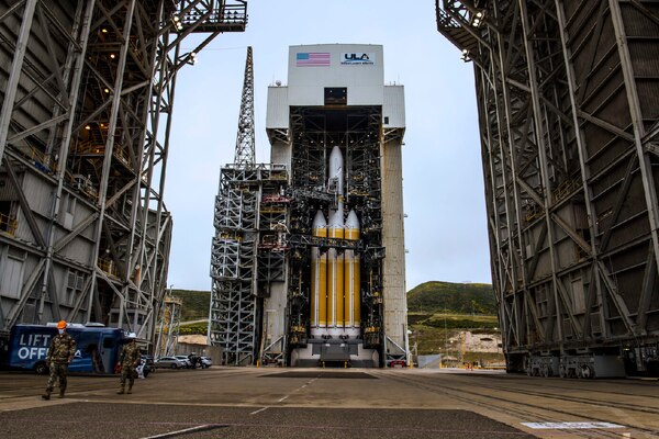 A rocket is photographed on a launchpad during daylight.