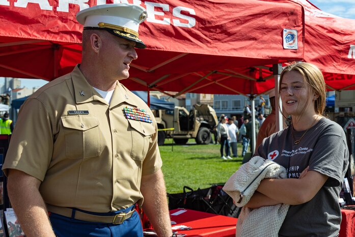 U.S. Marine Corps Col. Michael Ogden, left, commanding officer of 12th Marine Corps District, interacts with an expo attendee on the Marina Green during San Francisco Fleet Week 2024 in San Francisco, Oct. 13, 2024. SFFW, now in its 43rd iteration, is a time-honored sea service celebration that allows citizens of the Bay Area to witness today’s maritime capabilities firsthand. Nearly 2,500 Sailors, Marines, and Coast Guardsmen will showcase their capabilities and equipment, participate in various community service events, and enjoy the hospitality of the Bay Area during the event. (U.S. Marine Corps photo by Cpl. Bruin Largent)
