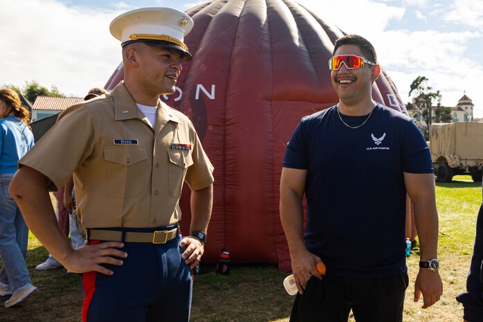 U.S. Marine Corps 1st Lt. Alejandro Rivas, left, the officer selection officer with Officer Selection Station San Jose, Recruiting Station San Francisco, interacts with an expo attendee on the Marina Green during San Francisco Fleet Week 2024 in San Francisco, Oct. 13, 2024. SFFW, now in its 43rd iteration, is a time-honored sea service celebration that allows citizens of the Bay Area to witness today’s maritime capabilities firsthand. Nearly 2,500 Sailors, Marines, and Coast Guardsmen will showcase their capabilities and equipment, participate in various community service events, and enjoy the hospitality of the Bay Area during the event. (U.S. Marine Corps photo by Cpl. Bruin Largent)