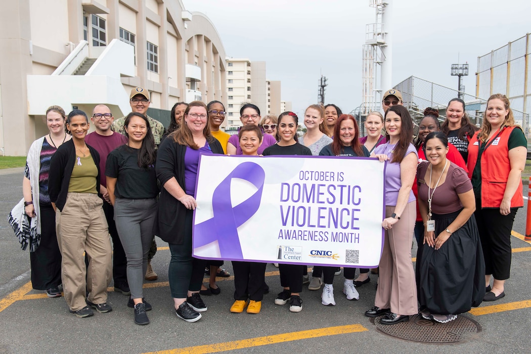 Commander, Fleet Activities Yokosuka Fleet and Family Support Center staff and base community members participated in the Walk a Mile in Their Shoes observance outside Purdy Fitness Center to raise awareness about domestic violence Thursday, October 17, 2024.