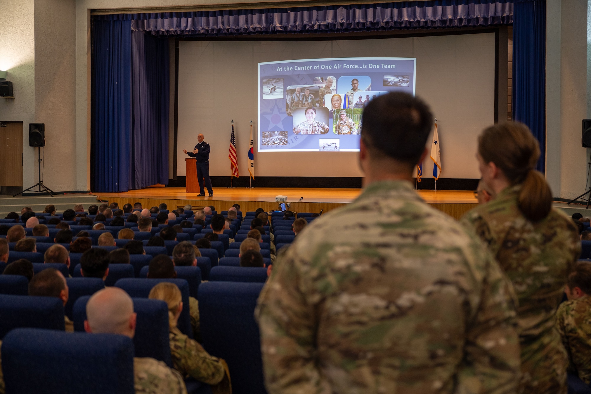 Chief of Staff of the Air Force Gen. David Allvin stands on stage in his blues as he answers questions from the audience at an all call at Osan Air Base, Republic of Korea, Oct. 17, 2024.