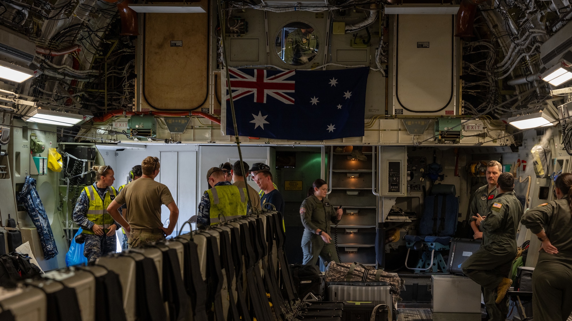 U.S. Airmen and Royal Australian Air Force stand inside of a C-17 Globemaster III.