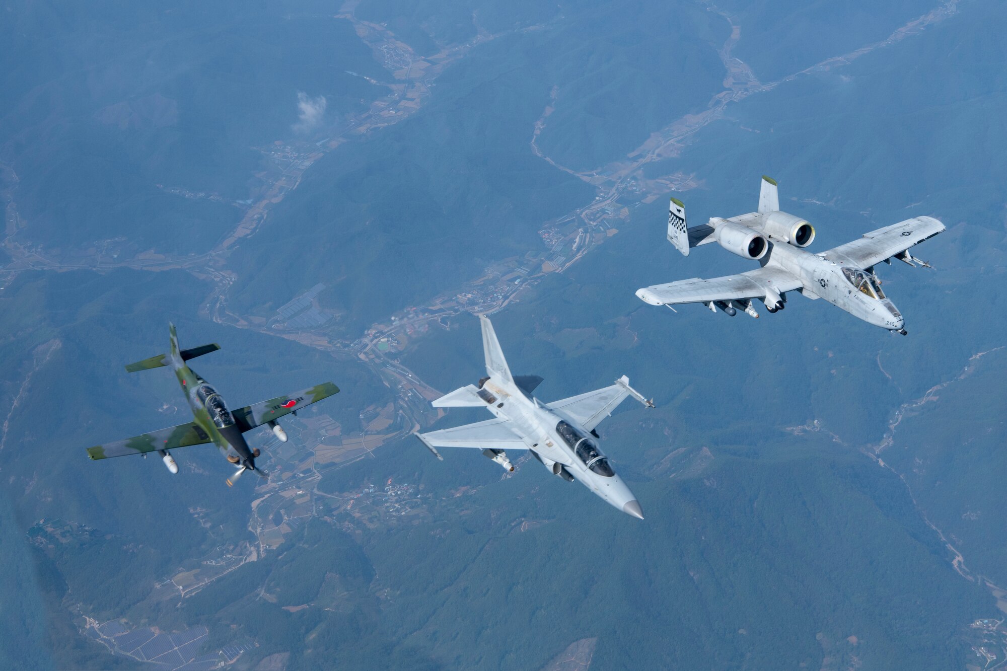 A Republic of Korea Air Force FA-50 Golden Eagle, right, and KA-1 Woongbi, left, assigned to the ROKAF 8th Fighter Wing train with an A-10 Thunderbolt II, center, assigned to the 25th Fighter Squadron during a Buddy Squadron 25-1 flight over Osan Air Base, ROK, Oct. 16, 2024. The purpose of the semi-annual event is to integrate U.S. Air Force and ROKAF units so that they can seamlessly collaborate if ever needed to defend the peninsula and “Fight Tonight.” (Courtesy Photo)