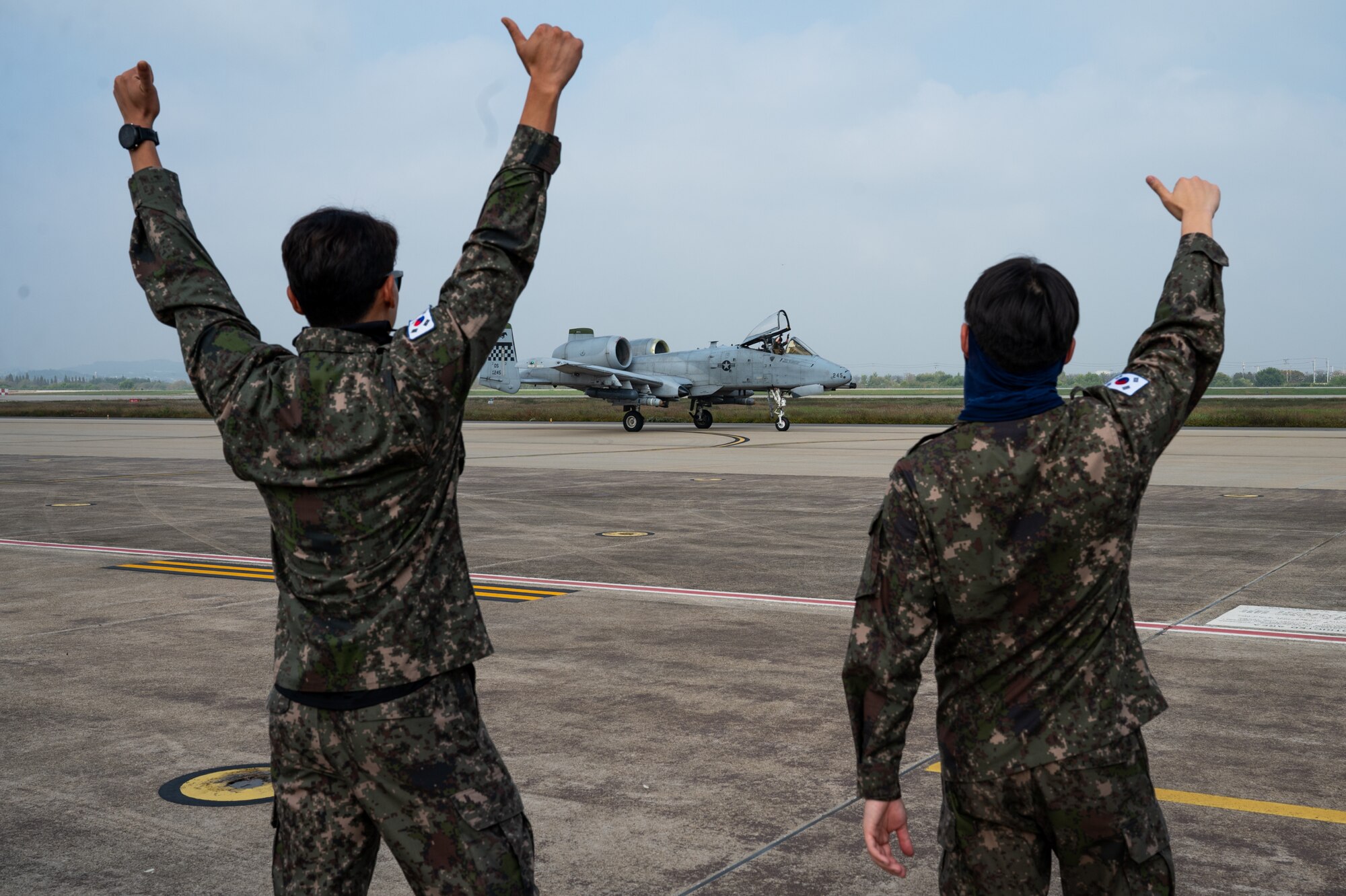 Republic of Korea Air Force members give thumbs up to an A-10 Thunderbolt II before take-off during Buddy Squadron 25-1 at Osan Air Base, Republic of Korea, Oct. 16, 2024. Buddy Squadron is a semi-annual event for each fighter squadron stationed in Korea where joint training missions are planned and executed between the collaborating units. (U.S. Air Force photo by Senior Airman Brittany Russell)