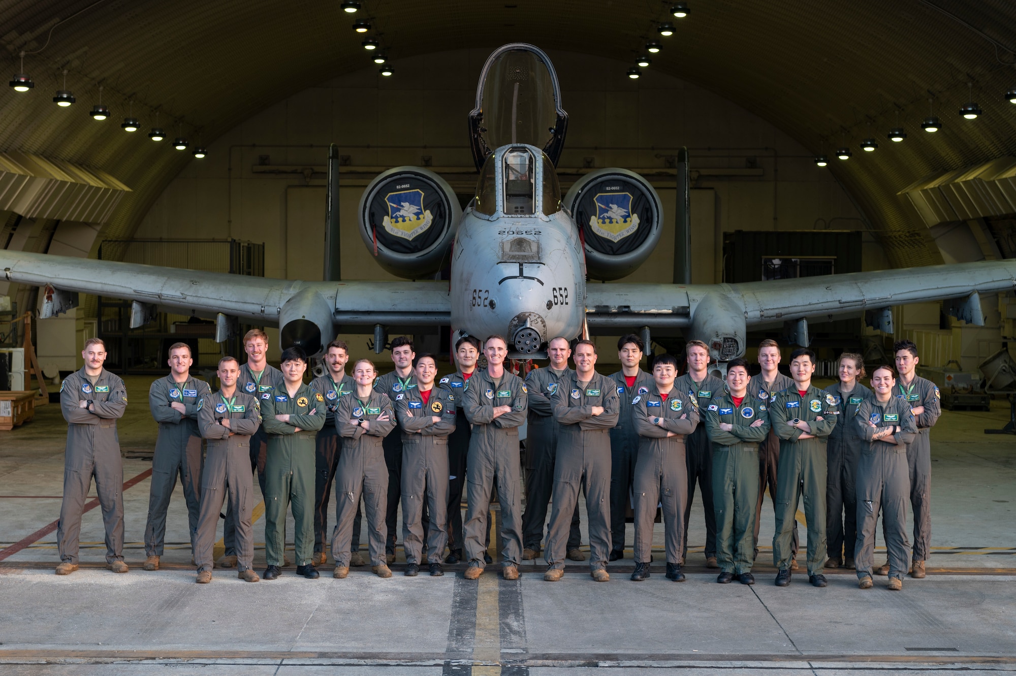 U.S. Air Force pilots assigned to the 25th Fighter Squadron and Republic of Korea pilots assigned to the 8th Fighter Wing pose for a group photo in front of an A-10 Thunderbolt II at Osan Air Base, ROK, Oct. 16, 2024. The units gathered to participate in their semi-annual Buddy Squadron event where ROKAF and U.S. Air Force pilots have the opportunity to share and practice flying concepts and tactics while building and developing relationships amongst their counterparts. (U.S. Air Force photo by Staff Sgt. Ashley N. Mikaio)