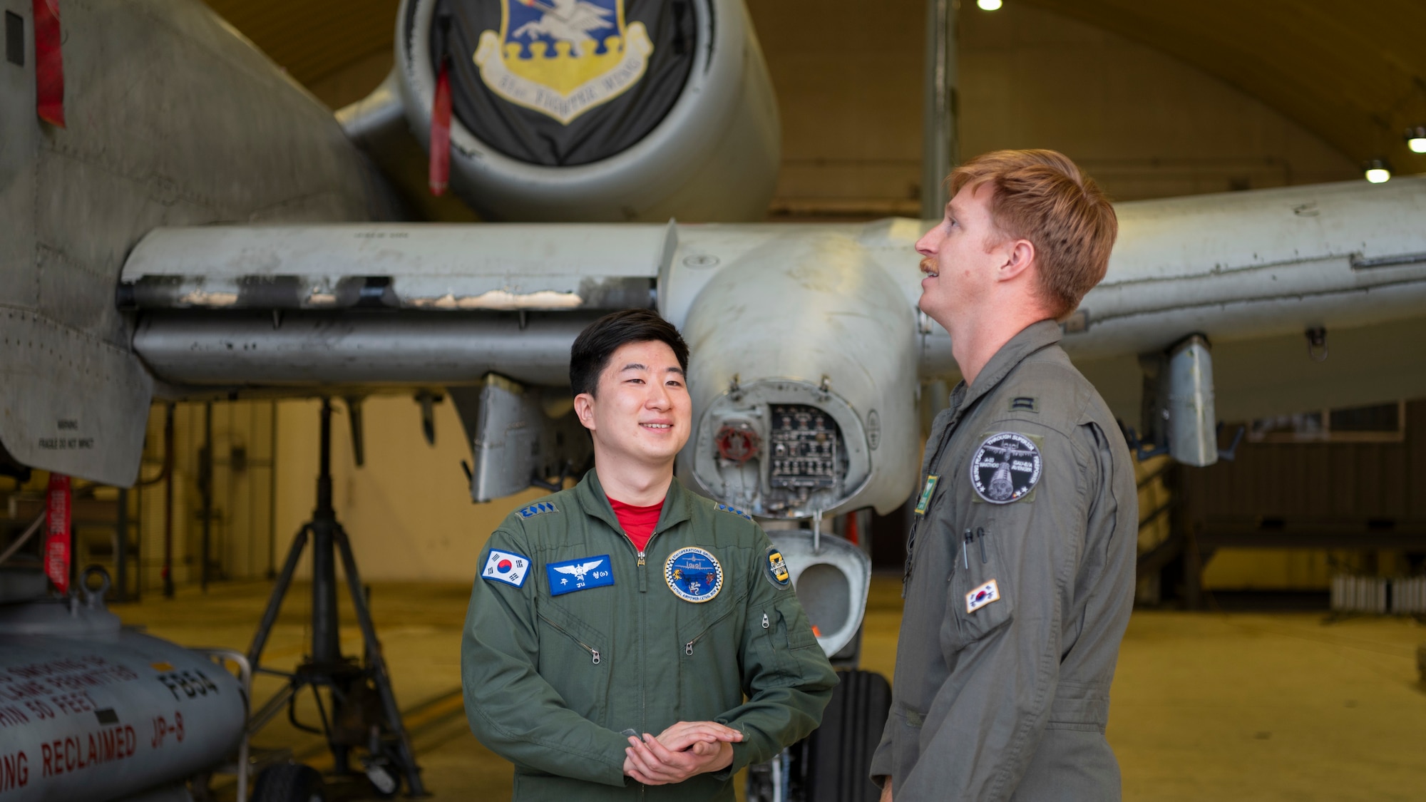 U.S. Air Force Capt. Noah Evans, 25th Fighter Squadron pilot, speaks to Republic of Korea Air Force Capt. Jehyeong Ju, ROKAF pilot, during Buddy Squadron 25-1 at Osan Air Base, ROK, Oct. 16, 2024. Buddy Squadron is a tradition unique to the ROK dating back to the late 1990s where pilots from the U.S. and Korea join forces to collaborate on training and exchange flying tactics and knowledge. (U.S. Air Force photo by Staff Sgt. Ashley N. Mikaio)