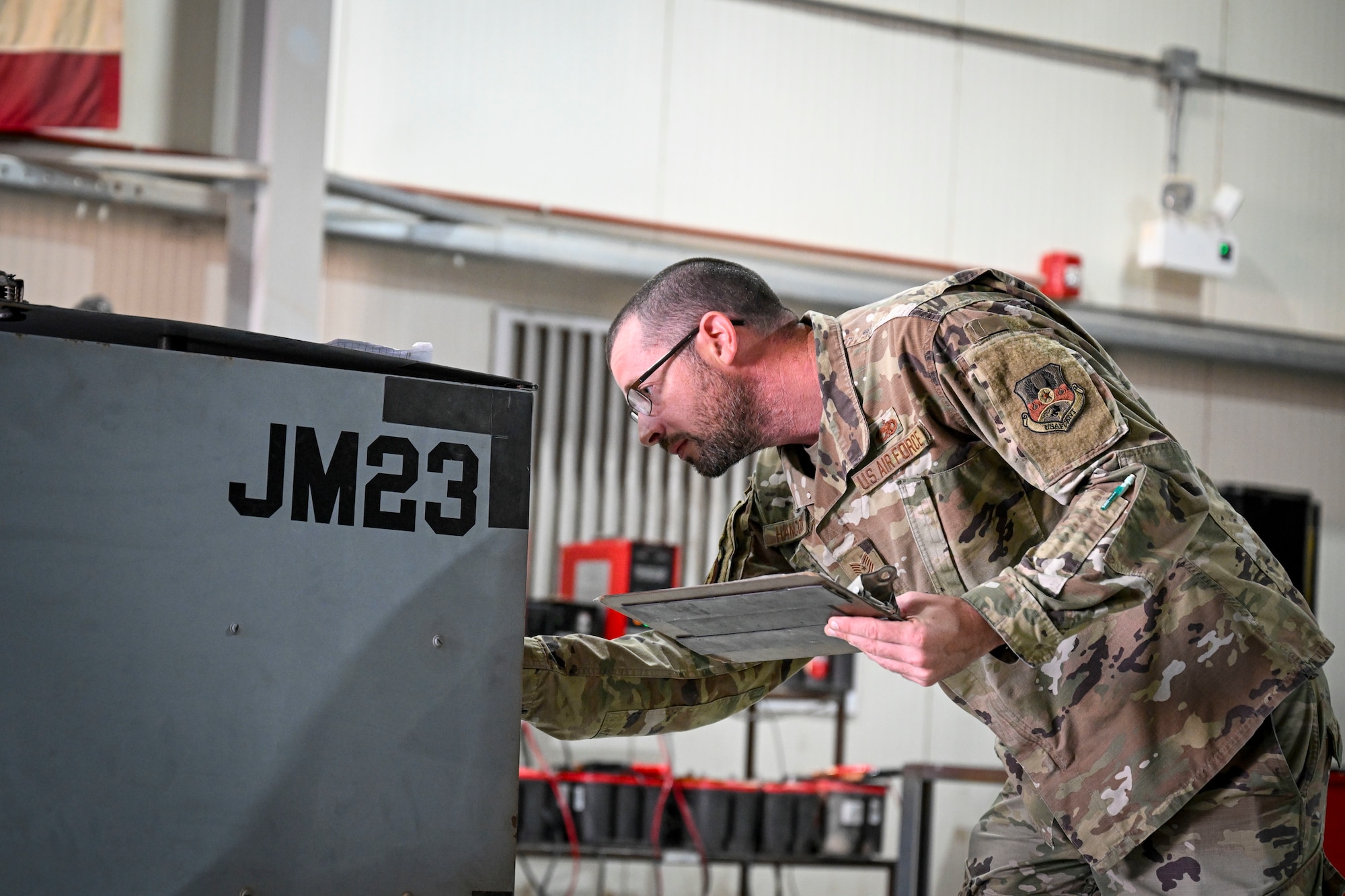 An Airman looks at a piece of equipment.