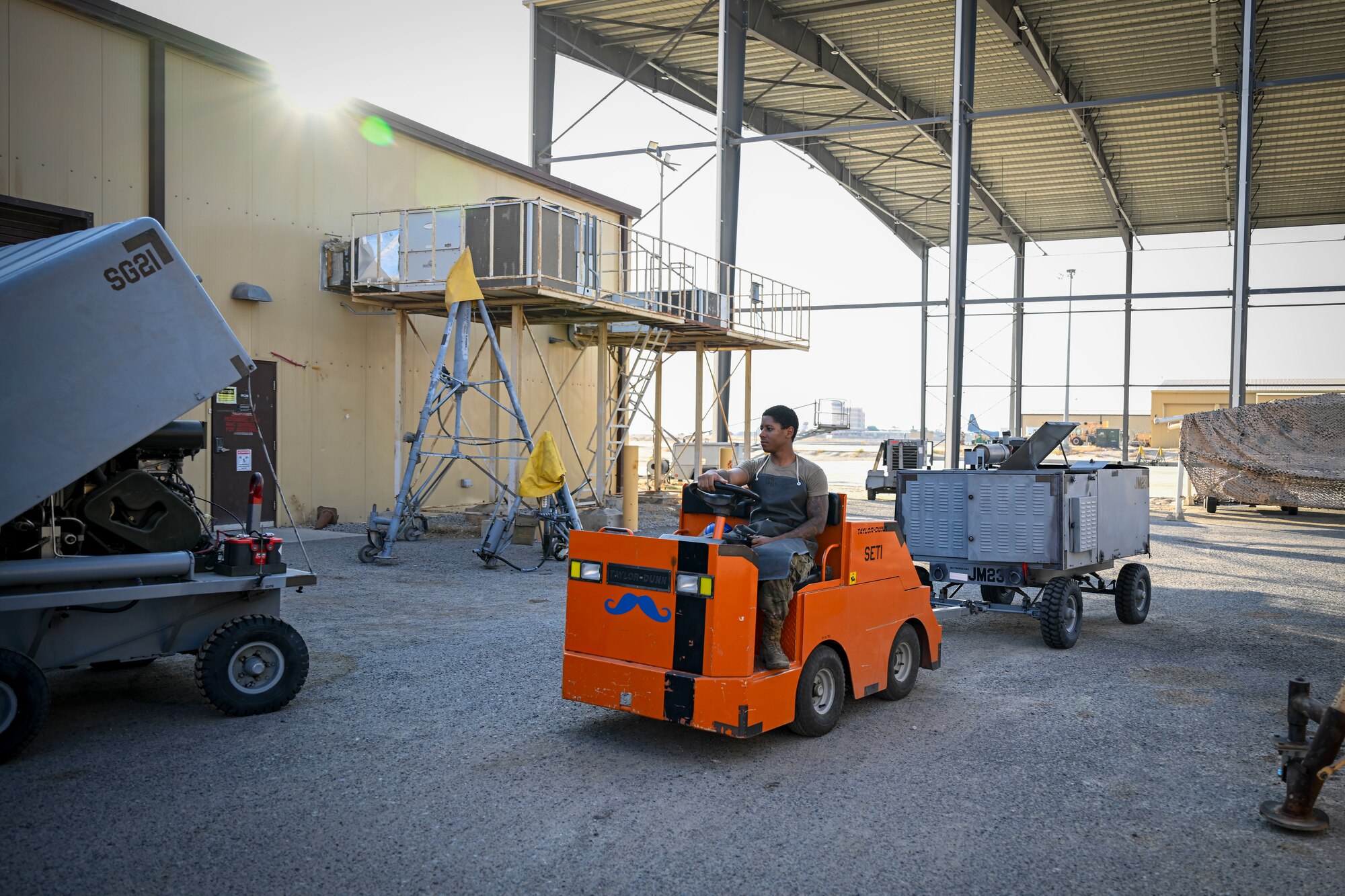 An Airman tows a piece of equipment.