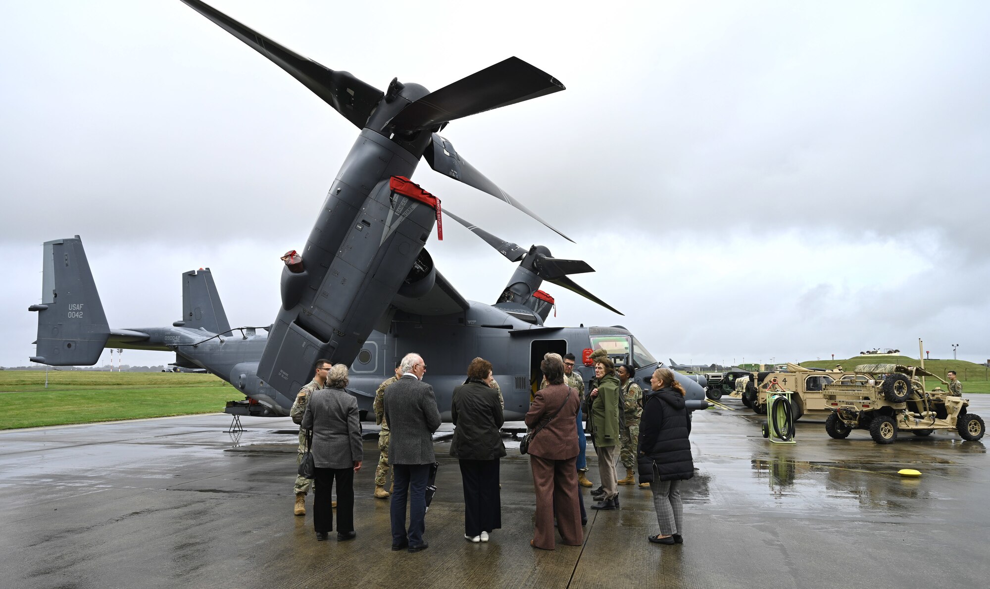 Vice Lord-Lieutenants, Deputy Lieutenants and High Sheriffs from Suffolk, Norfolk and Cambridgeshire, along with Royal Air Force representatives and other invited guests from the local community, tour a CV-22 Osprey aircraft and chat with U.S. Airmen assigned to the 7th Special Operations Squadron and 352nd Special Operations Wing at Royal Air Force Mildenhall, England, Oct. 9, 2024. The high sheriffs and deputy lieutenants toured the base as part of a familiarization visit to learn about Team Mildenhall's mission sets and global impact. (U.S. Air Force photo by Karen Abeyasekere)