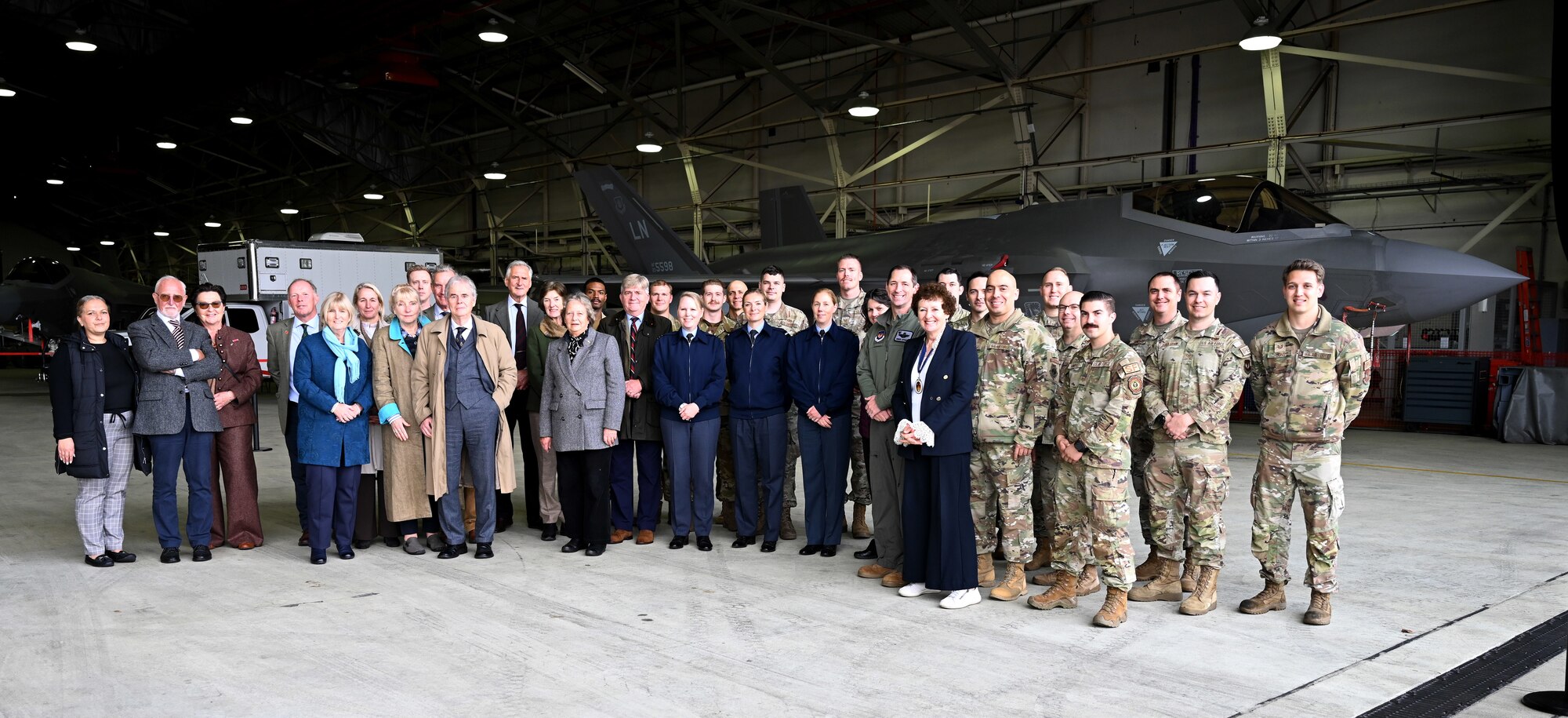 Members from the Liberty Wing, Vice Lord-Lieutenants, Deputy Lieutenants, High Sheriffs, Royal Air Force representatives and other invited guests from the local community gather in front of an F-35A Lightning II aircraft from the 48th Fighter Wing at Royal Air Force Lakenheath, England, Oct. 9, 2024. The event aimed to facilitate interactions between new appointees and base leadership, providing insights into the wing’s missions and showcasing various aircraft. (U.S. Air Force photo by Karen Abeyasekere)
