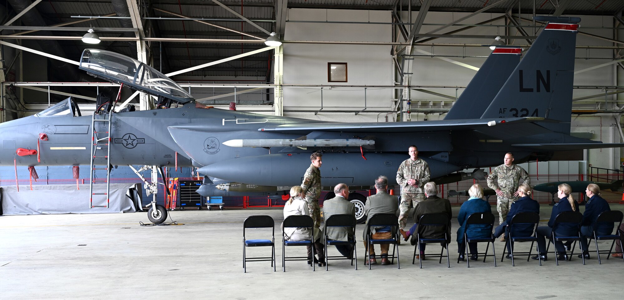 U.S. Airmen from the 48th Maintenance Group talk to Vice Lord-Lieutenants, Deputy Lieutenants, High Sheriffs, Royal Air Force representatives and other invited guests from the local community about capabilities of the F-15 Eagle at RAF Lakenheath, England, Oct. 9, 2024. The special event aimed to facilitate interactions between new appointees and base leadership, providing insights into the wing’s missions and showcasing various aircraft. (U.S. Air Force photo by Karen Abeyasekere)