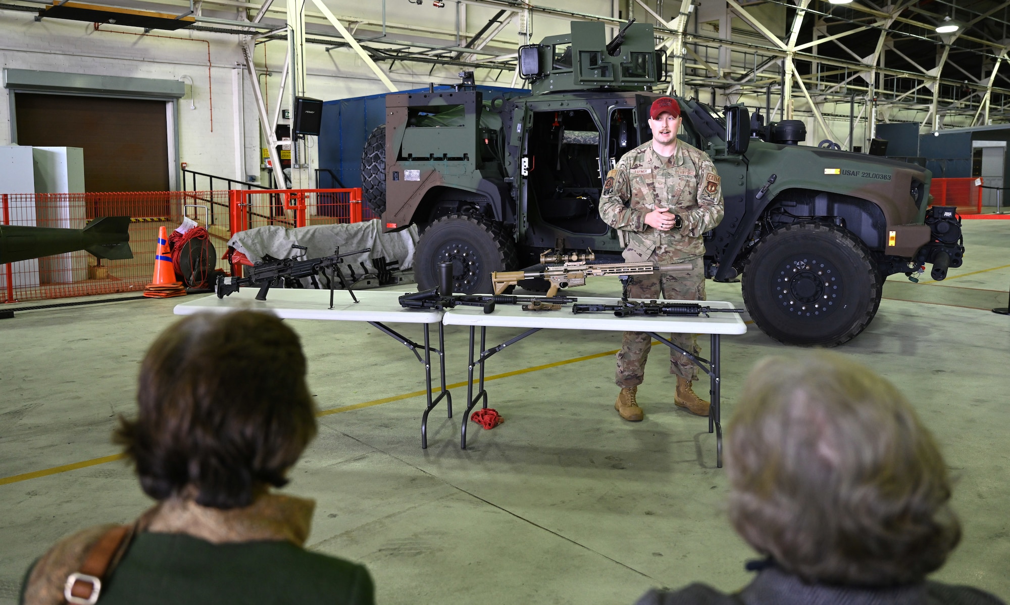 U.S. Air Force Senior Airman Ethan Farmer, 48th Security Forces Squadron Combat Arms Training and Maintenance instructor, talks to Vice Lord-Lieutenants, Deputy Lieutenants, High Sheriffs, Royal Air Force representatives and other invited guests from the local community at RAF Lakenheath, England, Oct. 9, 2024. The event aimed to facilitate interactions between new appointees and base leadership, providing insights into the wing’s missions and showcasing various aircraft. (U.S. Air Force photo by Karen Abeyasekere)