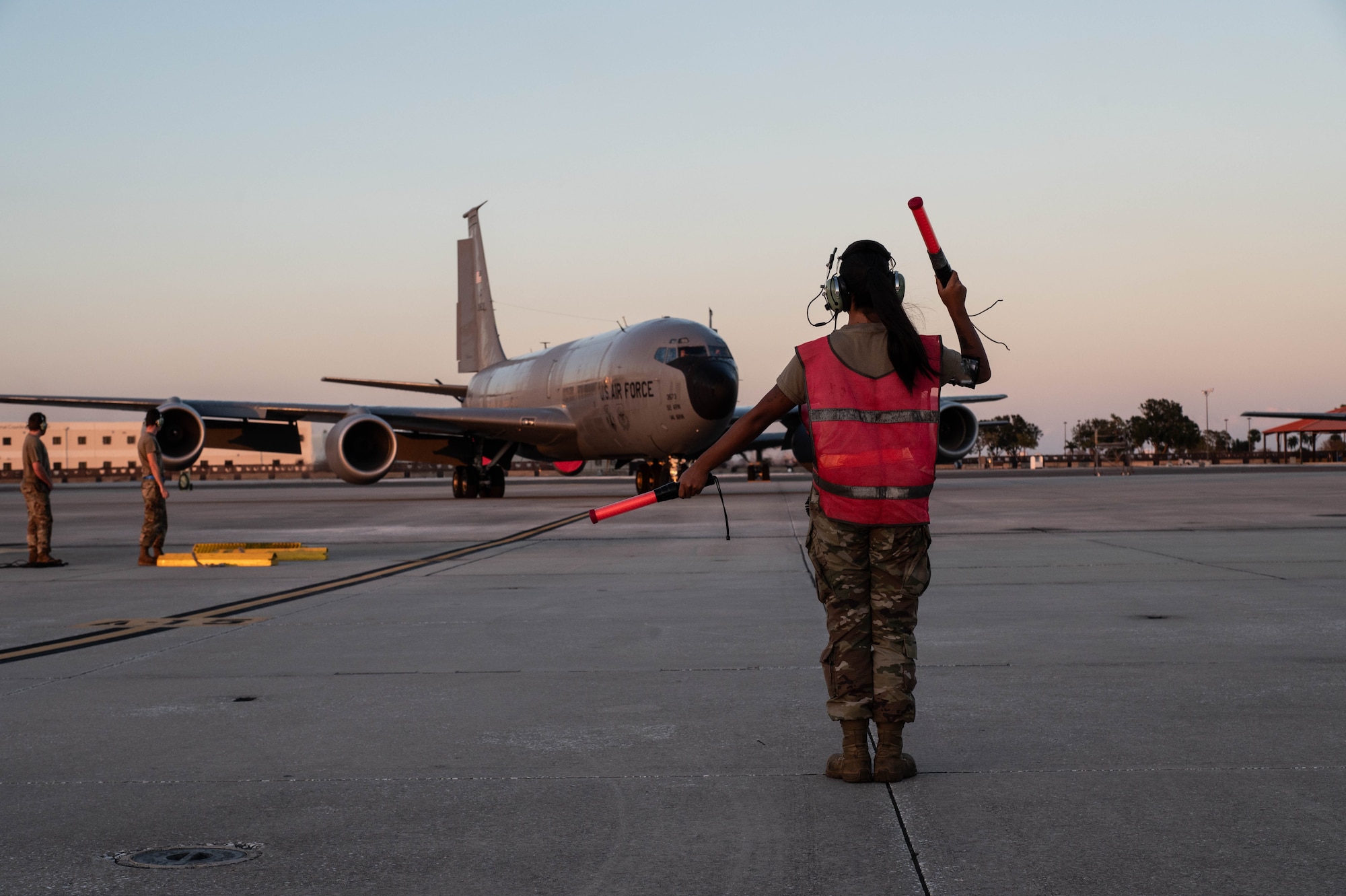 U.S. Air Force Airman 1st Class Summer Ko-Szych, a crew chief assigned to the 6th Aircraft Maintenance Squadron, marshals a KC-135 Stratotanker at MacDill Air Force Base, Florida, Oct. 13, 2024, following Hurricane Milton. Aircraft were relocated due to Hurricane Milton, which brought strong winds and heavy rain to the installation, in addition to downed trees and flooding in some low-lying areas. (U.S. Air Force photo by Senior Airman Sterling Sutton)