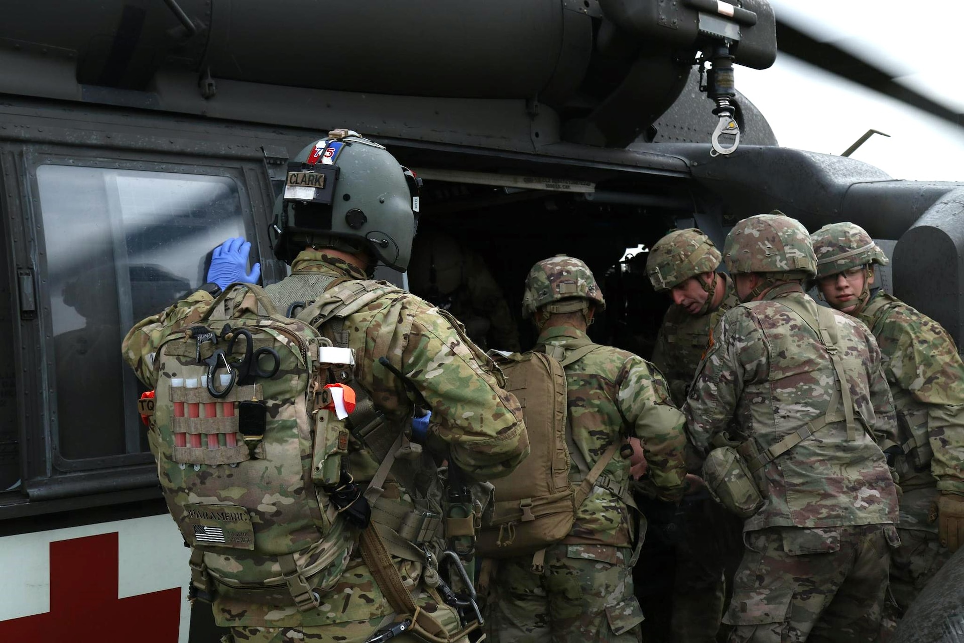 Sgt. Preston Clark with 12th Combat Aviation Brigade accompanies U.S. Soldiers with the Headquarters and Headquarters Company, 56th Stryker Brigade Combat Team, Pennsylvania National Guard as they transport a simulated wounded soldier to load onto the HH-60 Black Hawk helicopter during an air medevac exercise. U.S. Army medics rehearse their evacuation procedures to stand ready to respond to real life medical emergencies. (U.S. Army National Guard photo by Capt. Leanne Demboski)