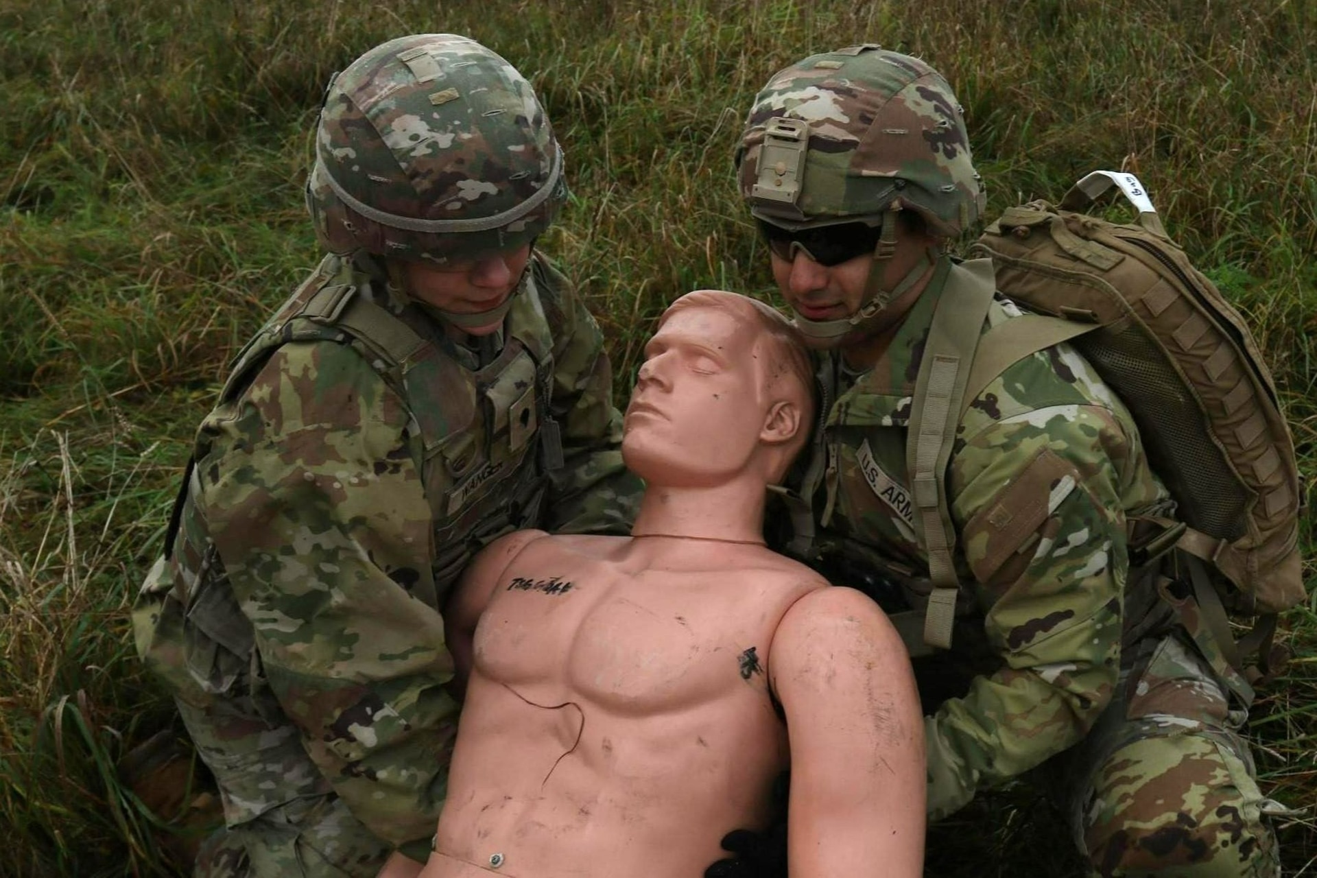 Spc. Jazmyne Wanger and Spc. Christian Torres with the Headquarters and Headquarters Company, 56th Stryker Brigade Combat Team, Pennsylvania National Guard tend to a simulated wounded soldier at an air medevac exercise at Grafenwoehr Training Area, Oct. 11, 2024. U.S. Army medics rehearse their evacuation procedures to stand ready to respond to real life medical emergencies. (U.S. Army National Guard photo by Capt. Leanne Demboski)