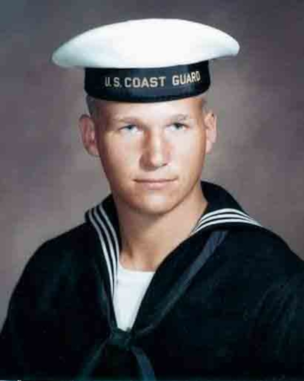 A man in a Coast Guard uniform poses for a photo.