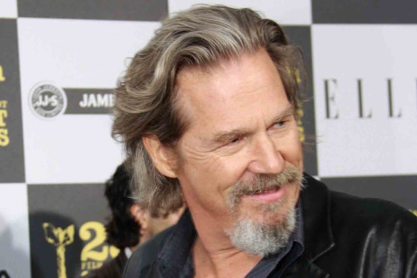 A man poses for a photo at an awards ceremony.