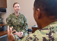 Lt. Amy Strickman, a psychologist at Naval Hospital Jacksonville, discusses mental health resiliency with a sailor.