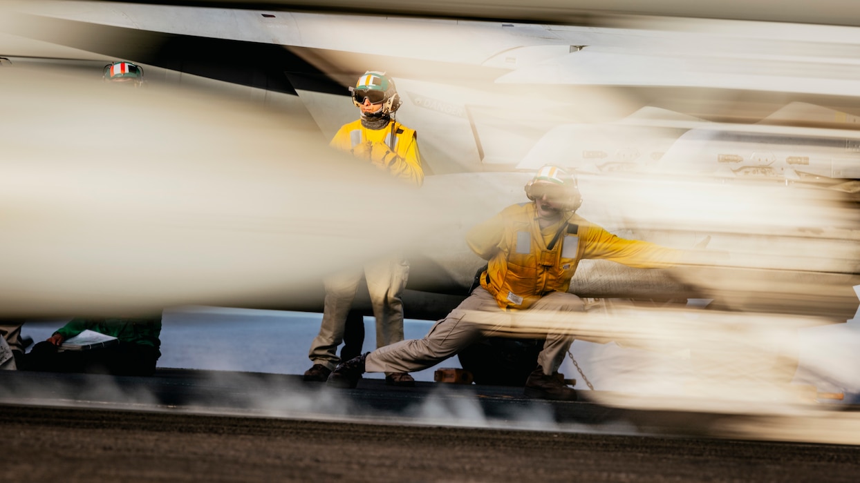 Lt. David Bailey gives the signal for an aircraft to launch from USS George Washington (CVN 73) in the Pacific Ocean.