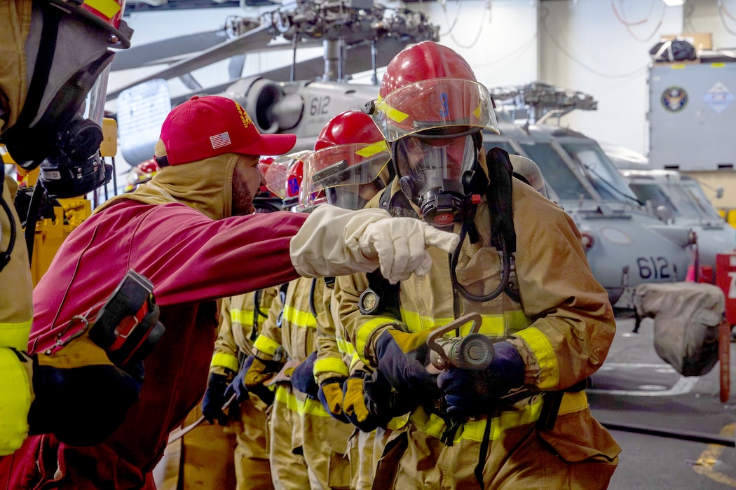 Sailors fight a simulated fire during a general quarters drill aboard USS Abraham Lincoln (CVN 72) in the U.S. 5th Fleet area of operations.