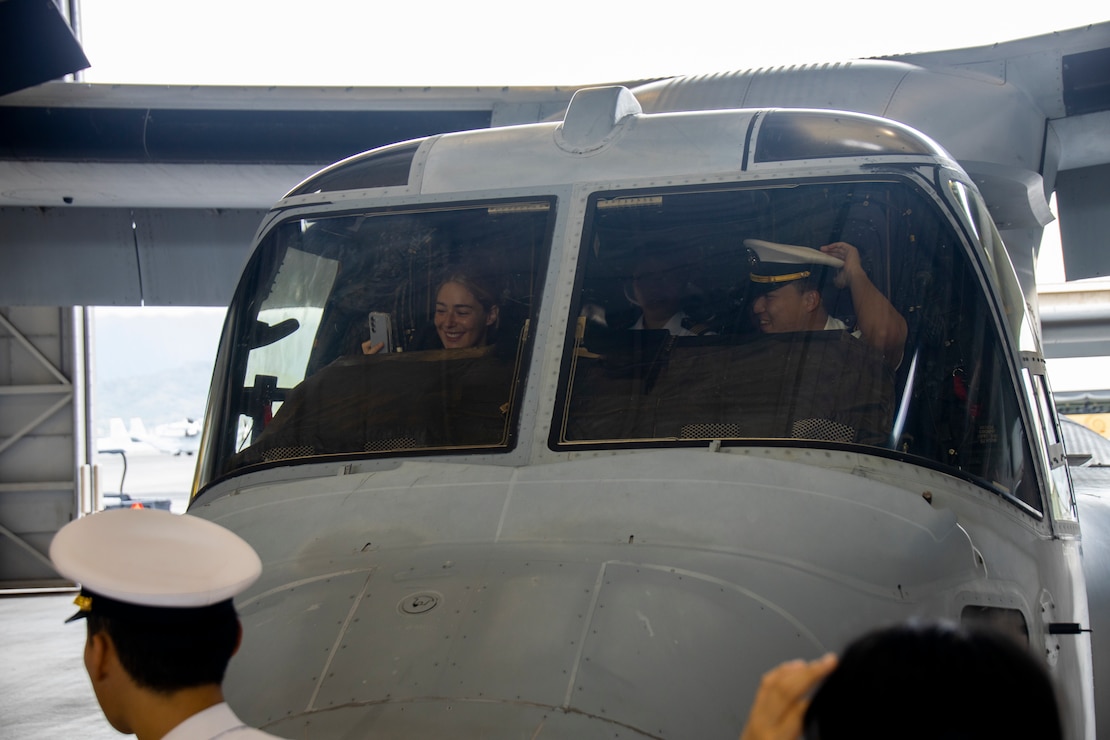 U.S. Marine Corps Capt. Hannah Briant, an MV-22B Osprey pilot with Marine Medium Tiltrotor Squadron (VMM) 363, Marine Aircraft Group 24, 1st Marine Aircraft Wing, guides Republic of Korea (ROK) service members through a tour of an MV-22B Osprey at Marine Corps Air Station (MCAS) Kaneohe Bay, Marine Corps Base Hawaii, Sept. 20, 2024. ROK service members and cadets received tours and educational briefs from VMM-363 and Marine Wing Support Squadron 174 to supplement their joint military knowledge, experience, and understanding of MCBH's mission. (U.S. Marine Corps photo by Sgt. Julian Elliott-Drouin)