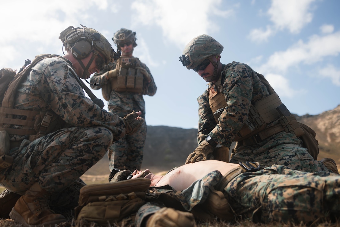 U.S. Marines with 3d Littoral Combat Team, 3d Marine Littoral Regiment, 3d Marine Division, conduct tactical combat casualty care on a simulated casualty during a squad attack range on Marine Corps Base Hawaii, Oct. 15, 2024. Squad-level live-fire training enhances combat readiness and maintains the proficiency of the Marine Corps rifle squad. (U.S. Marine Corps photo by Cpl. Eric Huynh)