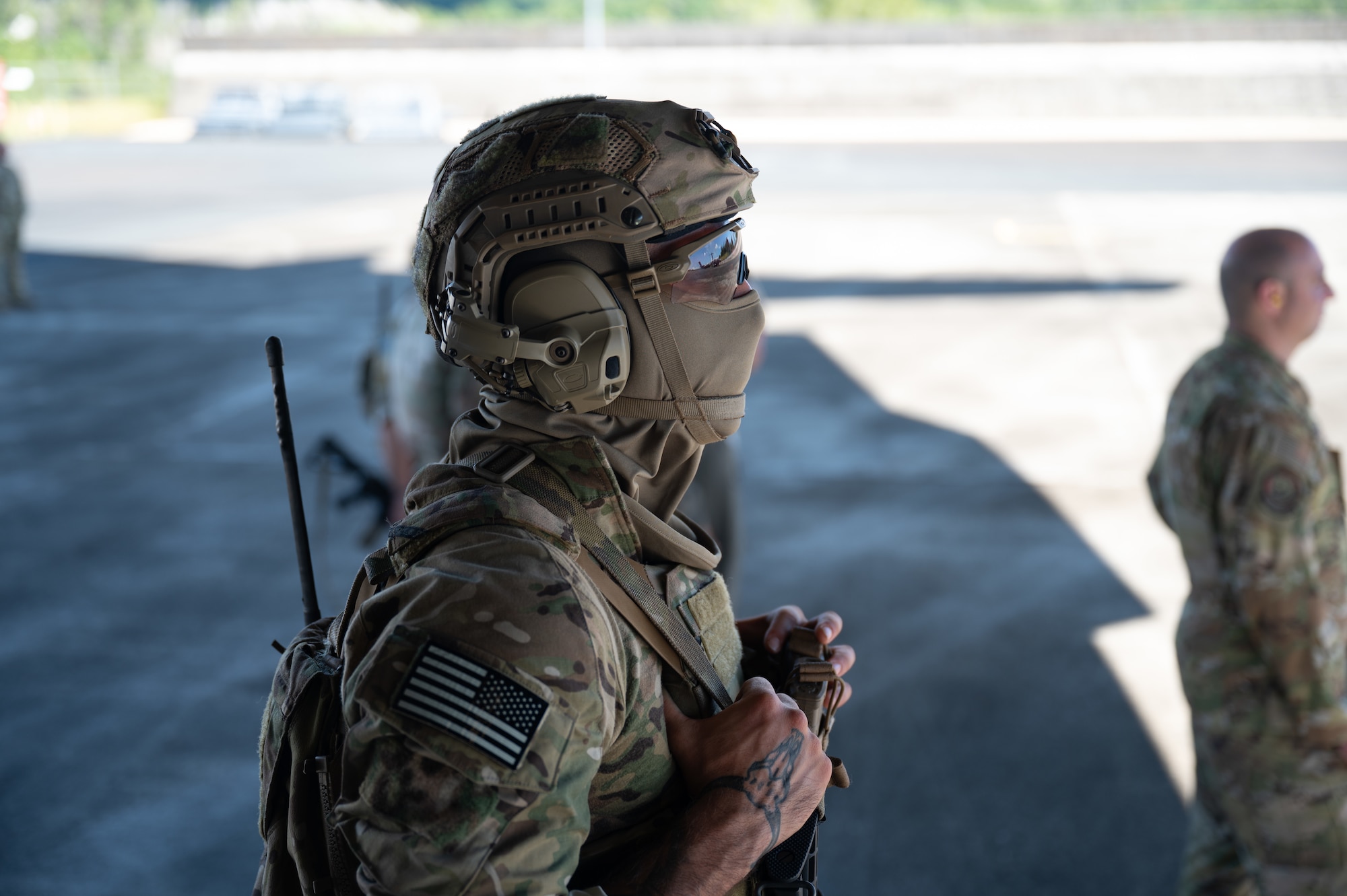 U.S. Army Soldier wears tactical equipment while looking outside.