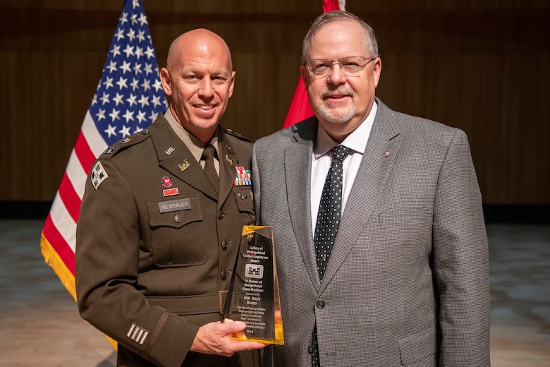 Bret Budd (right), a retired, longtime U.S. Army Corps of Engineers, Omaha District member, poses with Col. Robert Newbauer, commander, and his award after being inducted into the Gallery of Distinguished Civilian Employees during an award ceremony, Oct. 17, 2024, at the Holland Performing Arts Center in Omaha, Nebraska.
