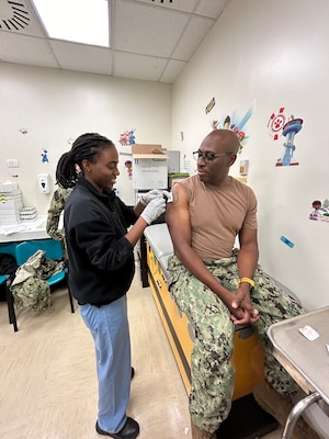 Capt. TaRail A. Vernon, NMRTC Sigonella Commanding Officer is one of the first to get his Influenza vaccine during the training kick off session in the Immunization Clinic at Medical Home Port at NMRTC Sigonella on Wednesday October 16,2024. HN Shanilee Nelson, one of our dental corpsman, volunteered to assist with the mass vaccination program going on throughout October and November.