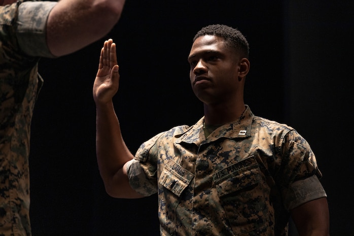 U.S. Marine Capt. Romarro Lamar, the operations officer of Recruiting Station Chicago, recites the oath of a Marine Corps Officer at his promotion ceremony at his high school, Downers Grove South, Downers Grove, Ill, October 10, 2024. Lamar’s promotion to the rank of captain indicates his exceptional professionalism, dedication, and potential, and incurs increased responsibility with greater opportunities to shape the Marine Corps. Lamar is a native of Downers Grove, a suburb of Chicago, Illinois. (U.S. Marine Corps photo by Sgt. Dalton J. Payne)