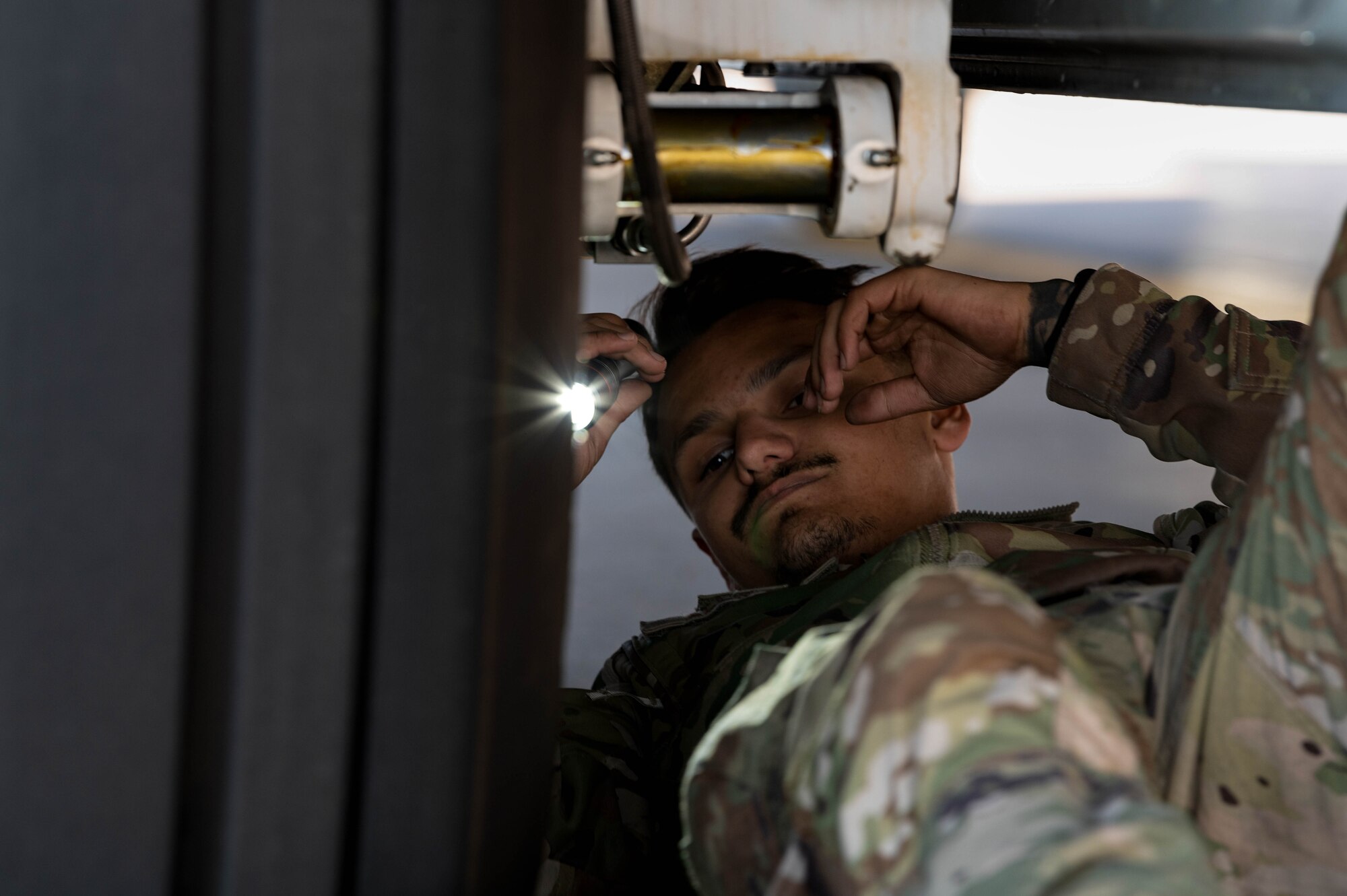 A U.S. Air Force crew chief, assigned to the 15th Special Operations Maintenance Squadron, conducts maintenance on an MC-130J Combat Talon II before take-off at Peterson Space Force Base, Colorado, Oct. 5, 2024.