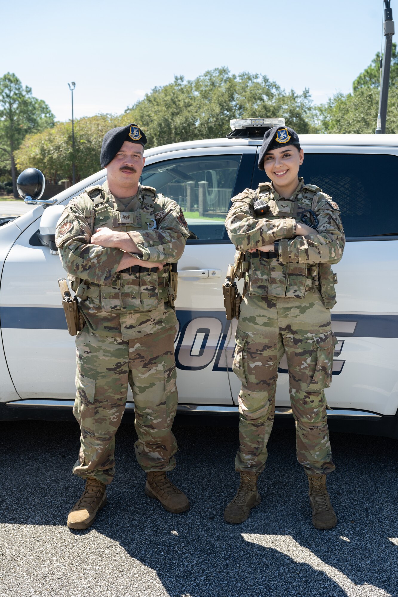 U.S. Air Force Staff Sgt. Justin Flinchum (left) and Airman 1st Class Lilia Perez, 1st Special Operations Security Forces Squadron patrolmen, pose for a photo at Hurlburt Field, Florida, Sept. 30, 2024.