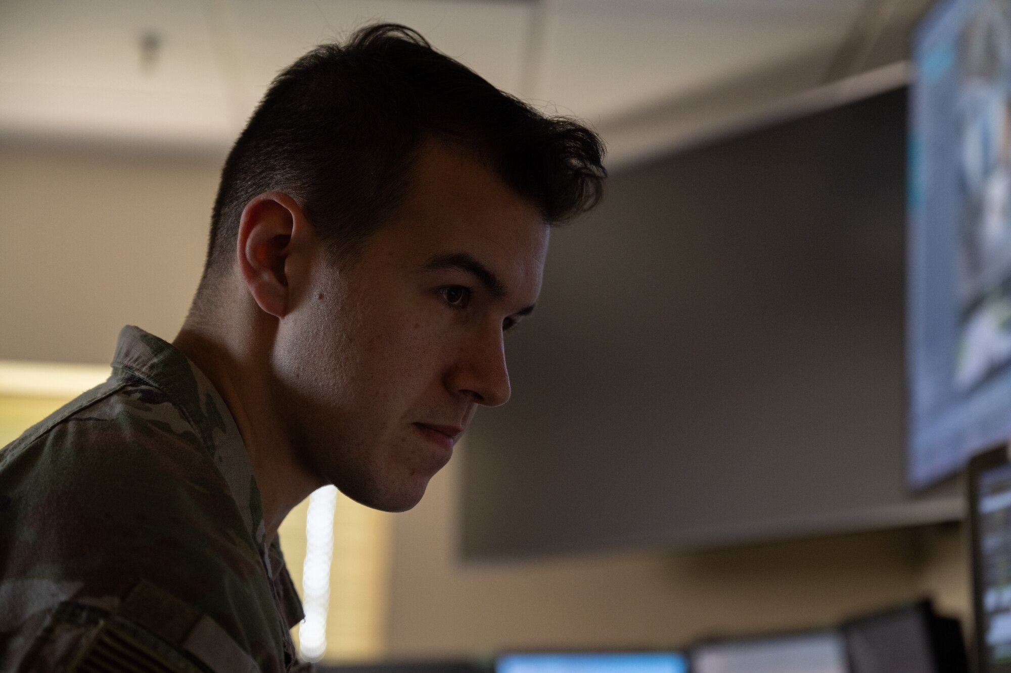 U.S. Air Force Staff Sgt. Garrett Huffman, 1st Special Operations Squadron Base Defense Operations Center controller, checks cameras for base activity at Hurlburt Field, Florida, Sept. 30, 2024.