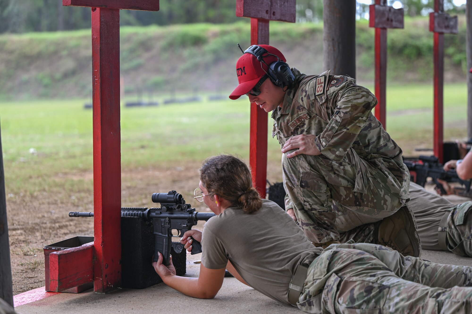 U.S. Air Force Senior Airman Logan Ramey, a 1st Special Operations Wing, Combat Arms Training and Maintenance Instructor, gives feedback to an Airman to help them qualify at the Combat Arms Training and Maintenance Range, Hurlburt Field, Florida, Sept. 25, 2024.