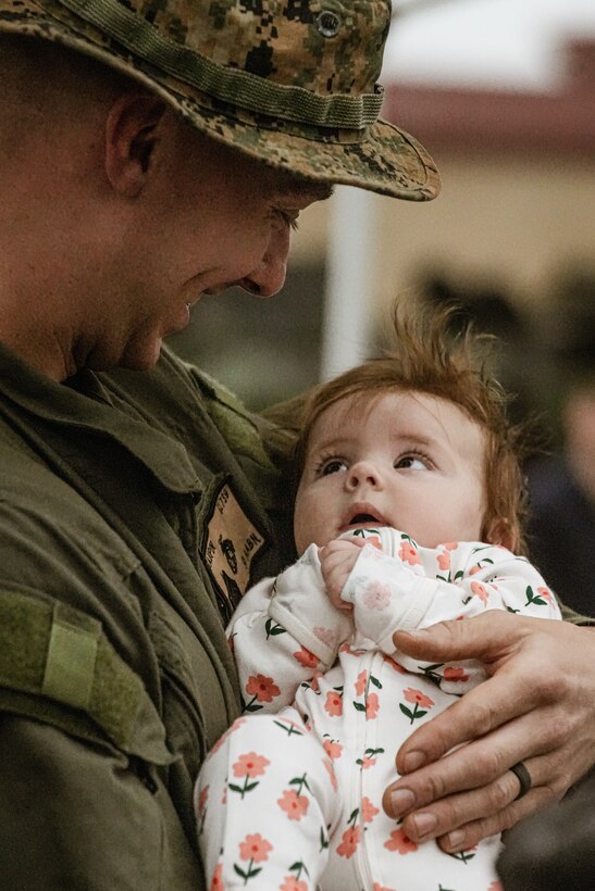 U.S. Marine Corps Sgt. Philip Maupin, a vehicle repair technician assigned to Alpha Company, Battalion Landing Team 1/5, 15th Marine Expeditionary Unit, holds his daughter after arriving at the Del Mar Boat Basin aboard Marine Corps Base Camp Pendleton, California Oct. 16, 2024.
