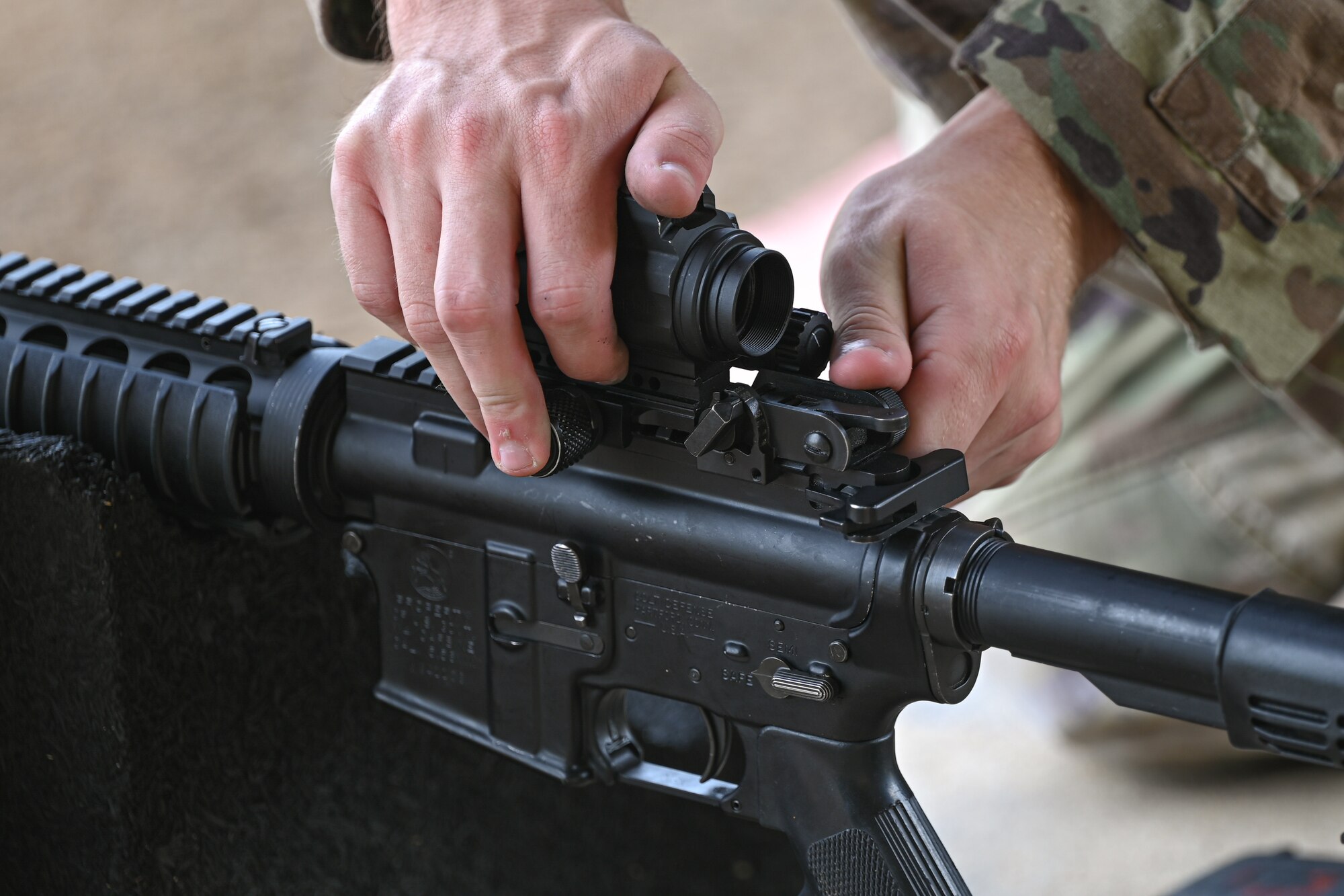 U.S. Air Force Senior Airman Logan Ramey, a Combat Arms Training and Maintenance instructor, adjusts the red dot on an M4 rifle at the Combat Arms Training and Maintenance Range, Hurlburt Field, Florida, Sept. 25, 2024.