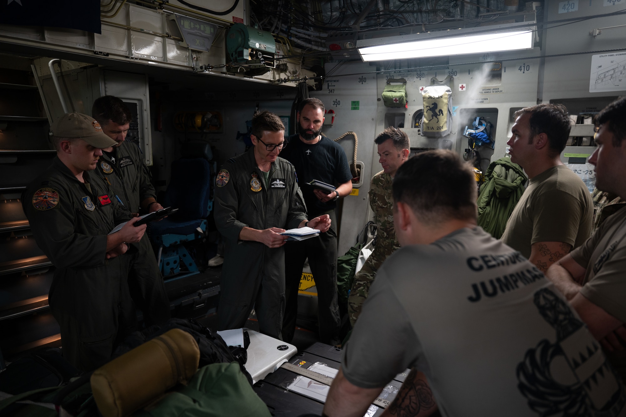 A group of U.S and Australian military members gather in a circle to discuss their plans during a training.