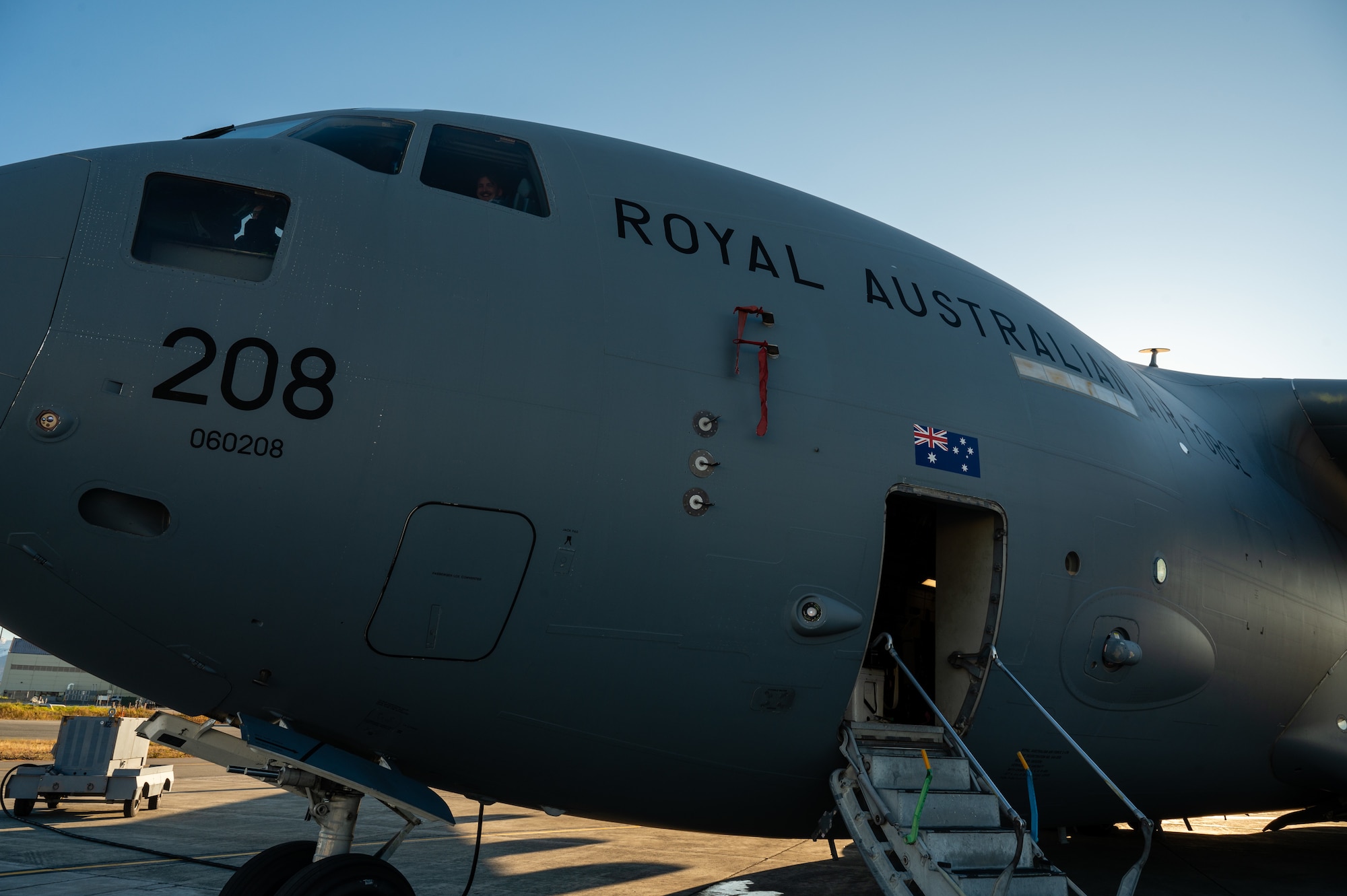 A Royal Australian Air Force C-17 Globemaster III aircraft is parked on an airfield during the Joint Pacific Multinational Readiness Center 25-01 exercise.