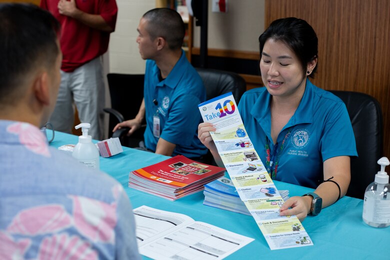 Hawaii Department of Health representatives from the Public Health Nursing Branch talk with Honolulu District staff during the District’s 30th Annual Fun Run/Walk and Safety Day October 18, 2024. Safety day plays a key role in promoting safety and health awareness to help reduce accidents and stay healthy.