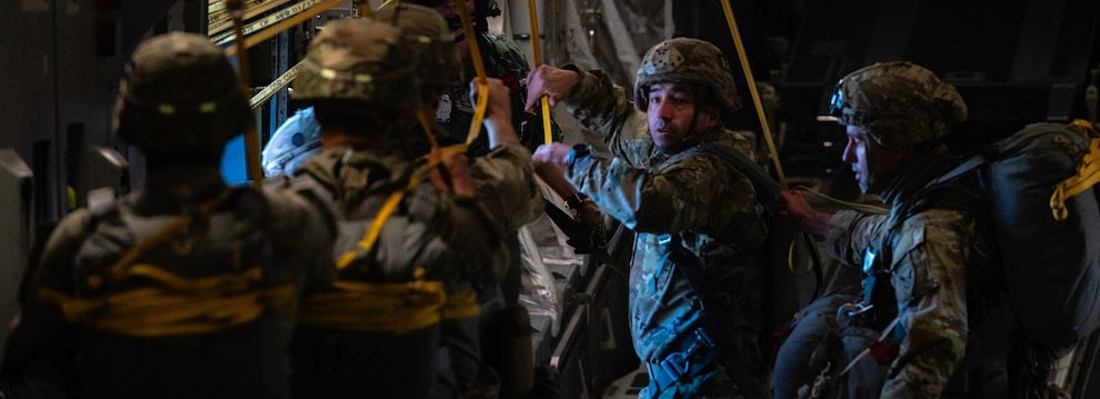 U.S. Army Soldiers assigned to the 2nd Infantry Brigade, 11th Airborne Division rush out of a Royal Australian C-17 Globemaster III during Joint Pacific Multinational Readiness Center 25-01, flying over the Pacific Ocean, Oct. 15, 2024.