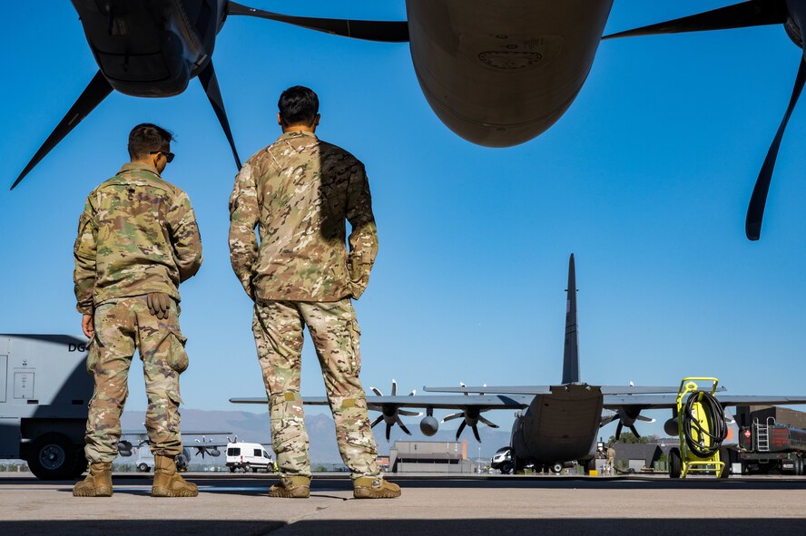 A U.S. Air Force crew chief, left, assigned to the 15th Special Operations Maintenance Squadron, and a special missions aviator, assigned to the 15th Special Operations Squadron, prepare to board an MC-130J Combat Talon II at Peterson Space Force Base, Colorado, Oct. 5, 2024.