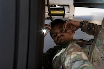 A U.S. Air Force crew chief, assigned to the 15th Special Operations Maintenance Squadron, conducts maintenance on an MC-130J Combat Talon II before take-off at Peterson Space Force Base, Colorado, Oct. 5, 2024.
