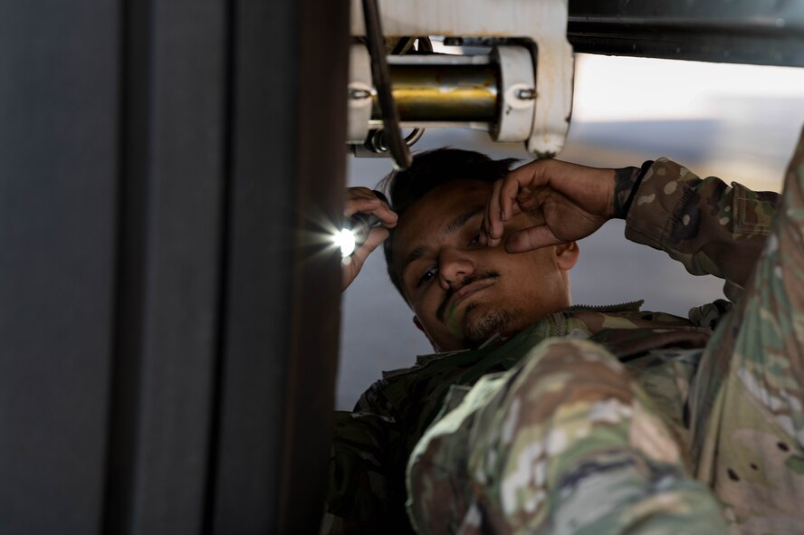 A U.S. Air Force crew chief, assigned to the 15th Special Operations Maintenance Squadron, conducts maintenance on an MC-130J Combat Talon II before take-off at Peterson Space Force Base, Colorado, Oct. 5, 2024.