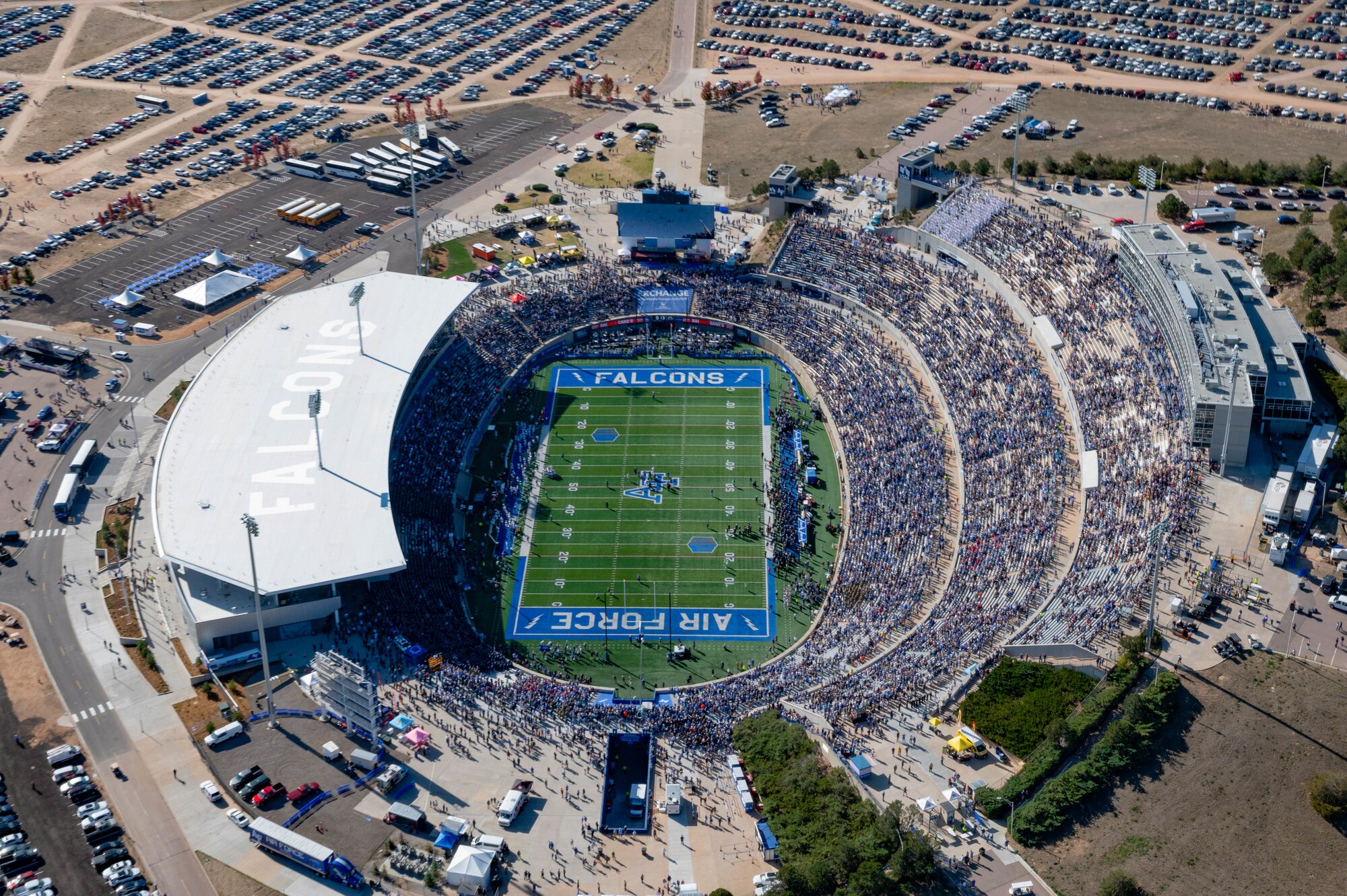 Spectators of the Navy vs Air Force football game watch as Air Force Special Operations Command aircraft conduct a flyover at United States Air Force Academy, Colorado, Oct. 5, 2024.