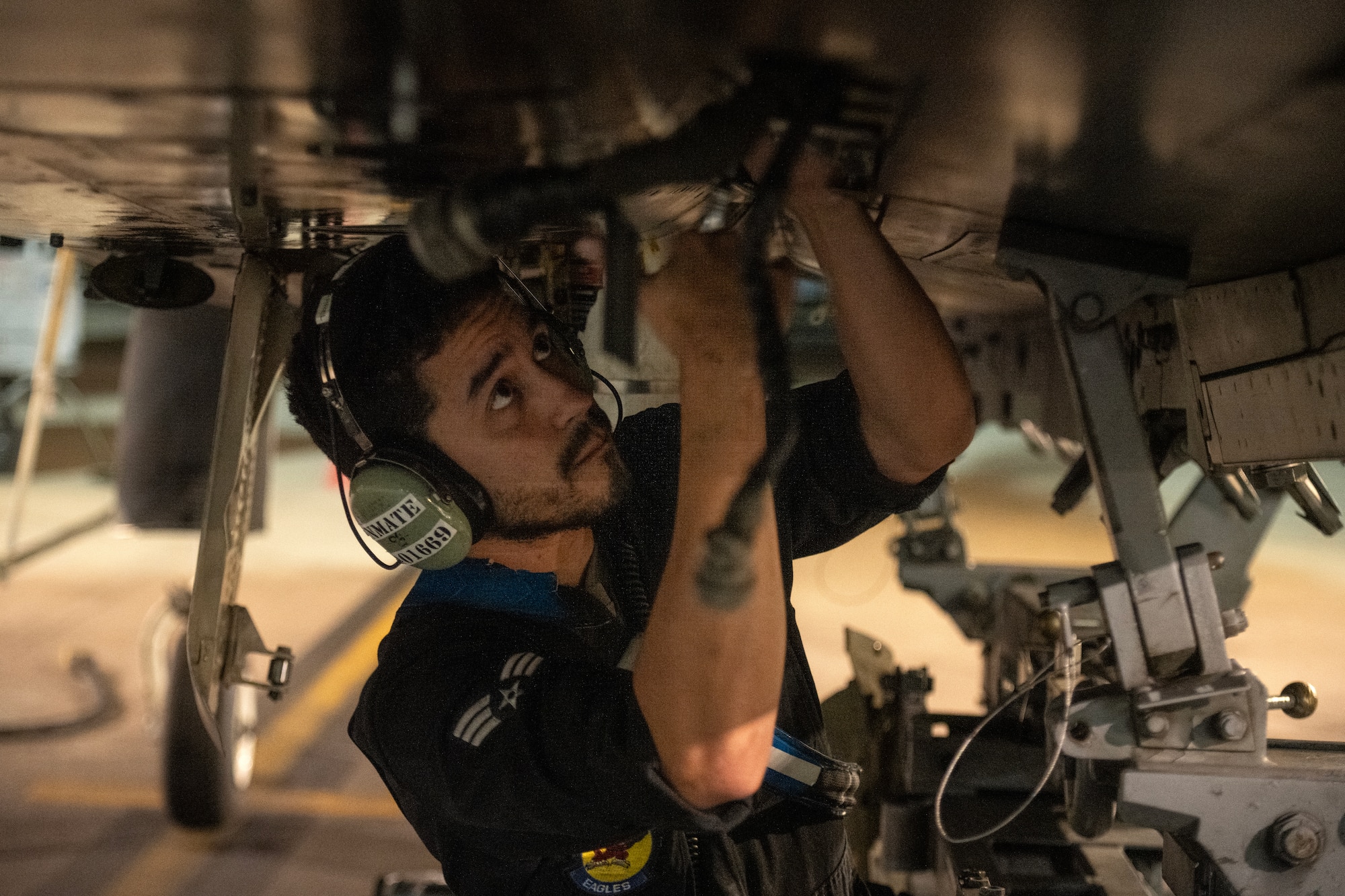 Senior Airman  Kent Dominicci, 334th Fighter Generation Squadron dedicated crew chief, performs maintenance on an F-15E Strike Eagle.