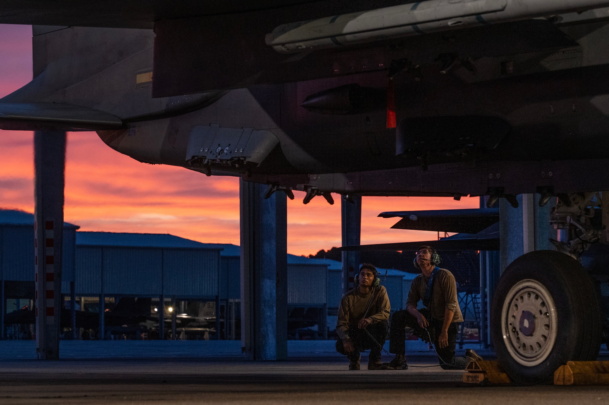 Airmen assigned to the 334th Fighter Generation Squadron perform pre-flight checks for an F-15E Strike Eagle .