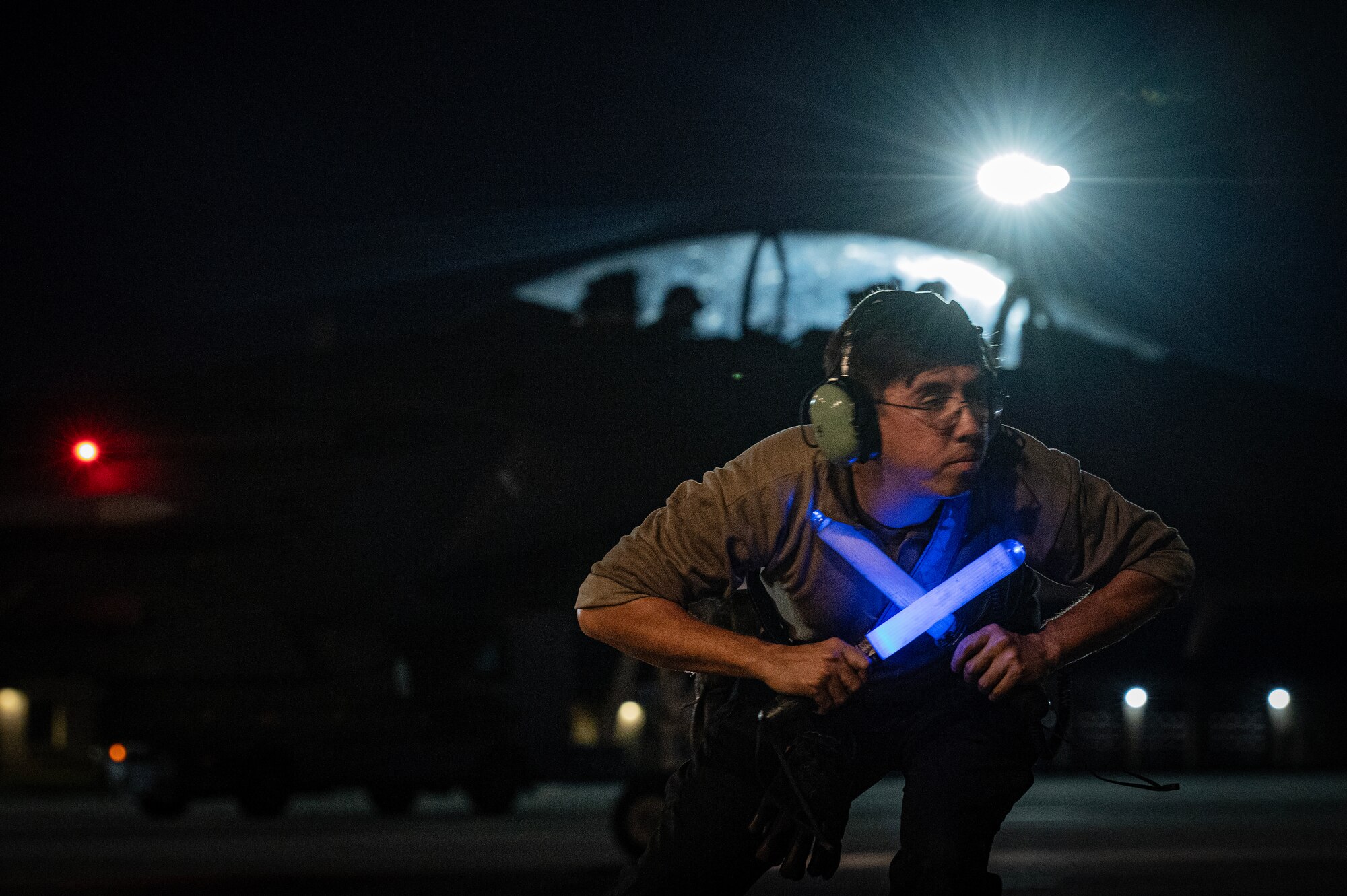 A1C Abram, 334th Fighter Generation Squadron assistant dedicated crew chief, marshals out an F-15E Strike Eagle.
