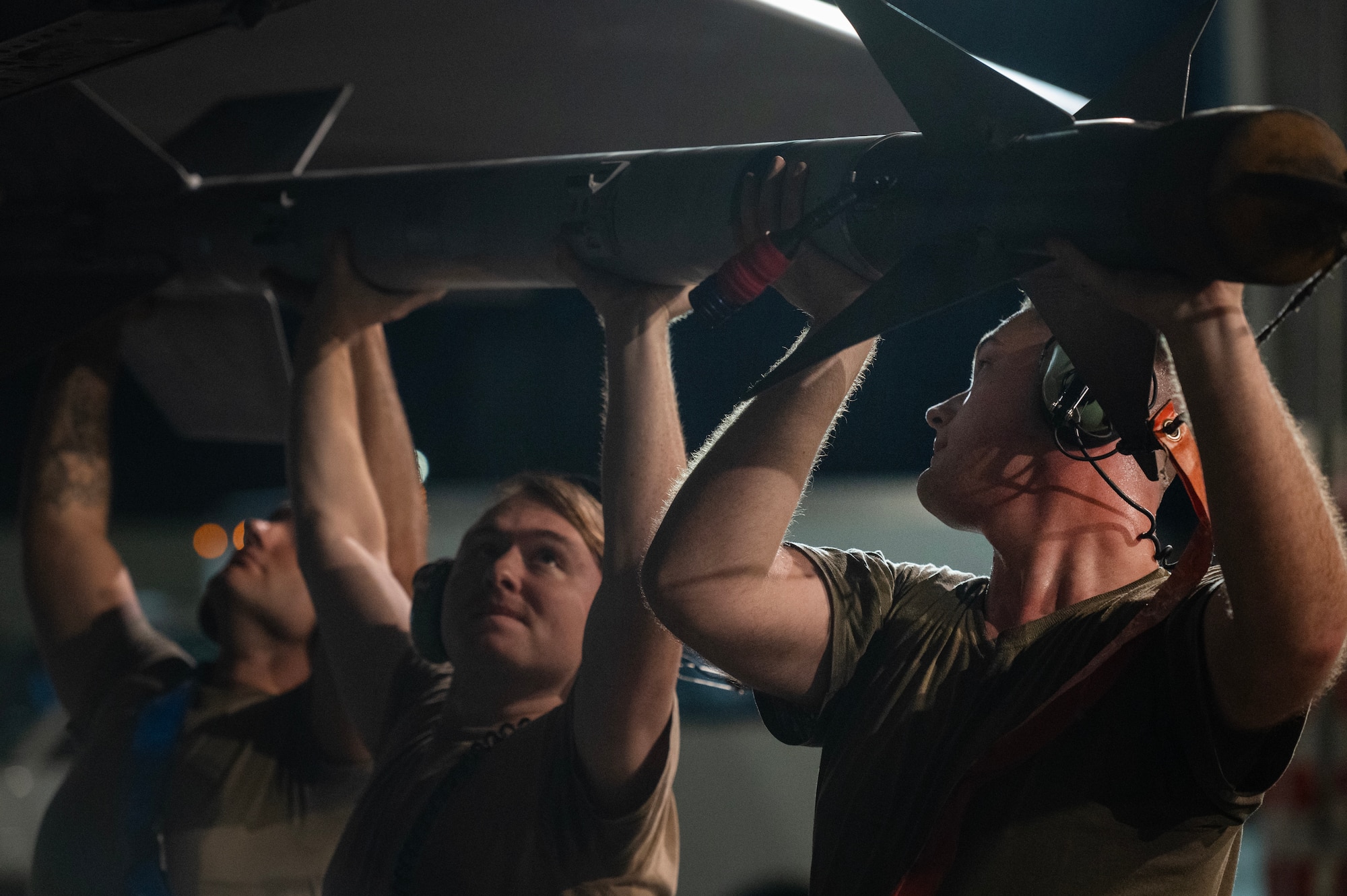 Airmen offload a dummy munition from an F-15E Strike Eagle.