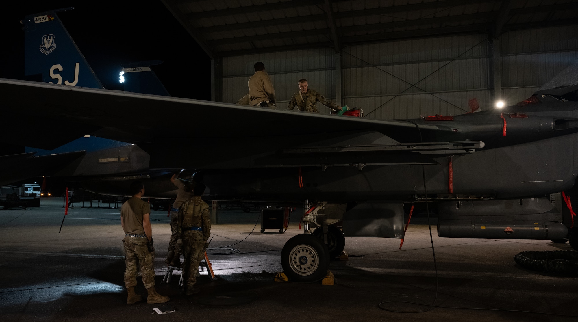 Airmen assigned to the 334th Fighter Generation Squadron perform maintenance on an F-15E Strike Eagle during the “Super Nights” event at Seymour Johnson Air Force Base.