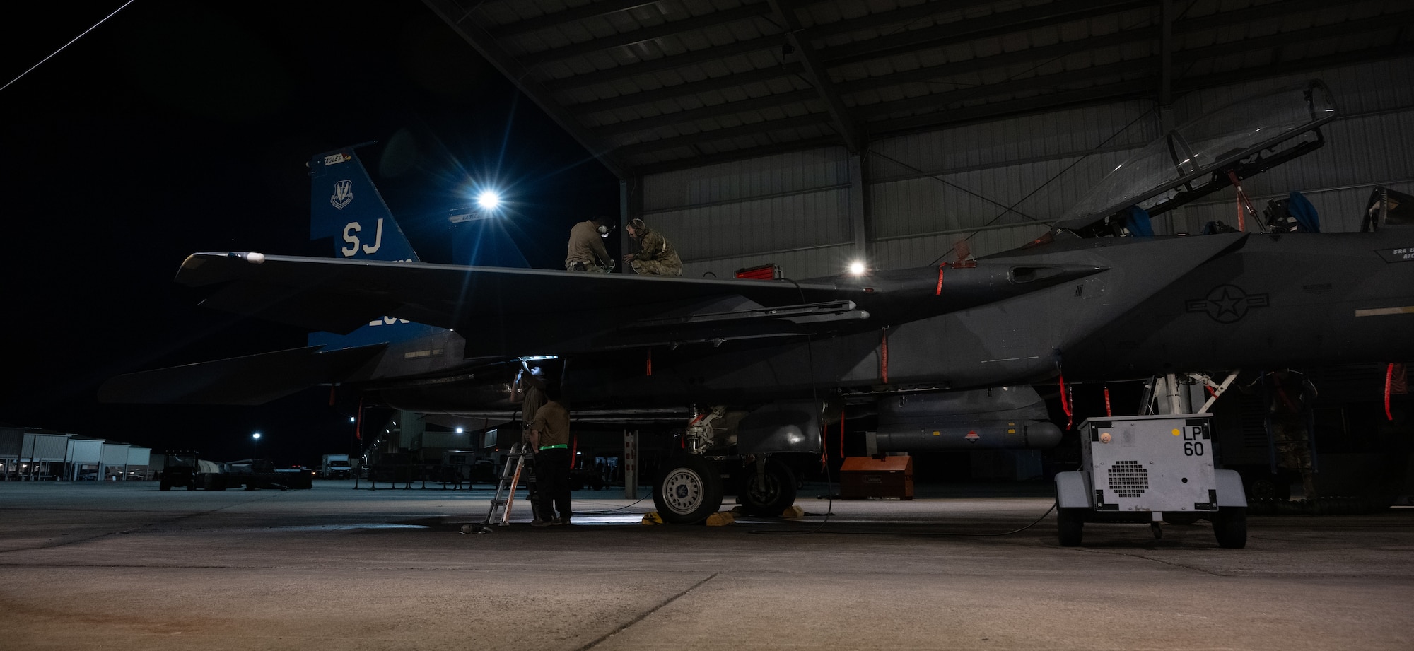 U.S. Air Force Airmen perform maintenance on an F-15E Strike Eagle during a “Super Nights” training event at Seymour Johnson Air Force Base.